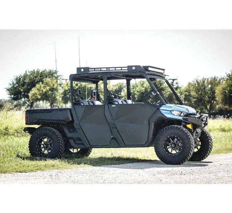 Can-Am Defender side-by-side vehicle with off-road accessories including roof rack, winch, and rugged tires parked outdoors