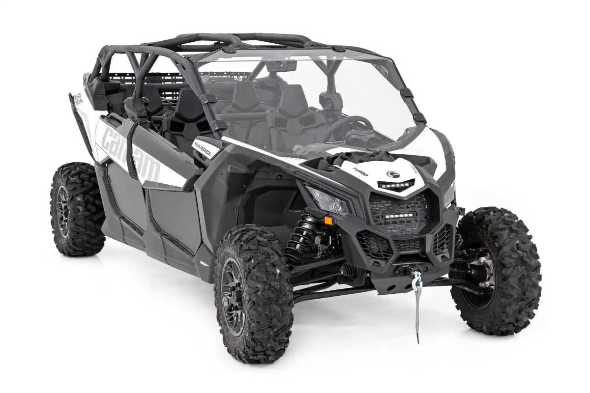 Can-Am X3 off-road vehicle with front-mounted winch and aggressive tires on white background