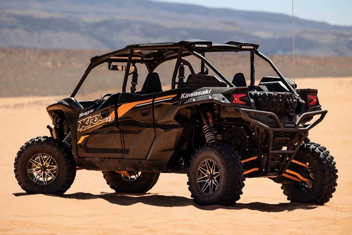 Kawasaki KRX 1000 4-Seater black off-road UTV parked on desert terrain with rugged tires and roll cage