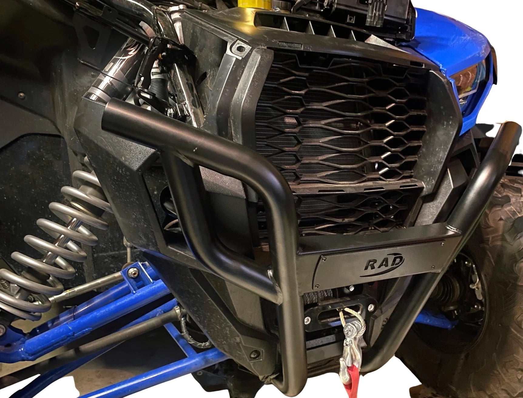 Front black steel KRX 1000 bumper with winch mount installed on blue off-road vehicle