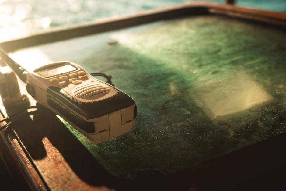 best walkie talkie device on dusty glass table with sunlit background