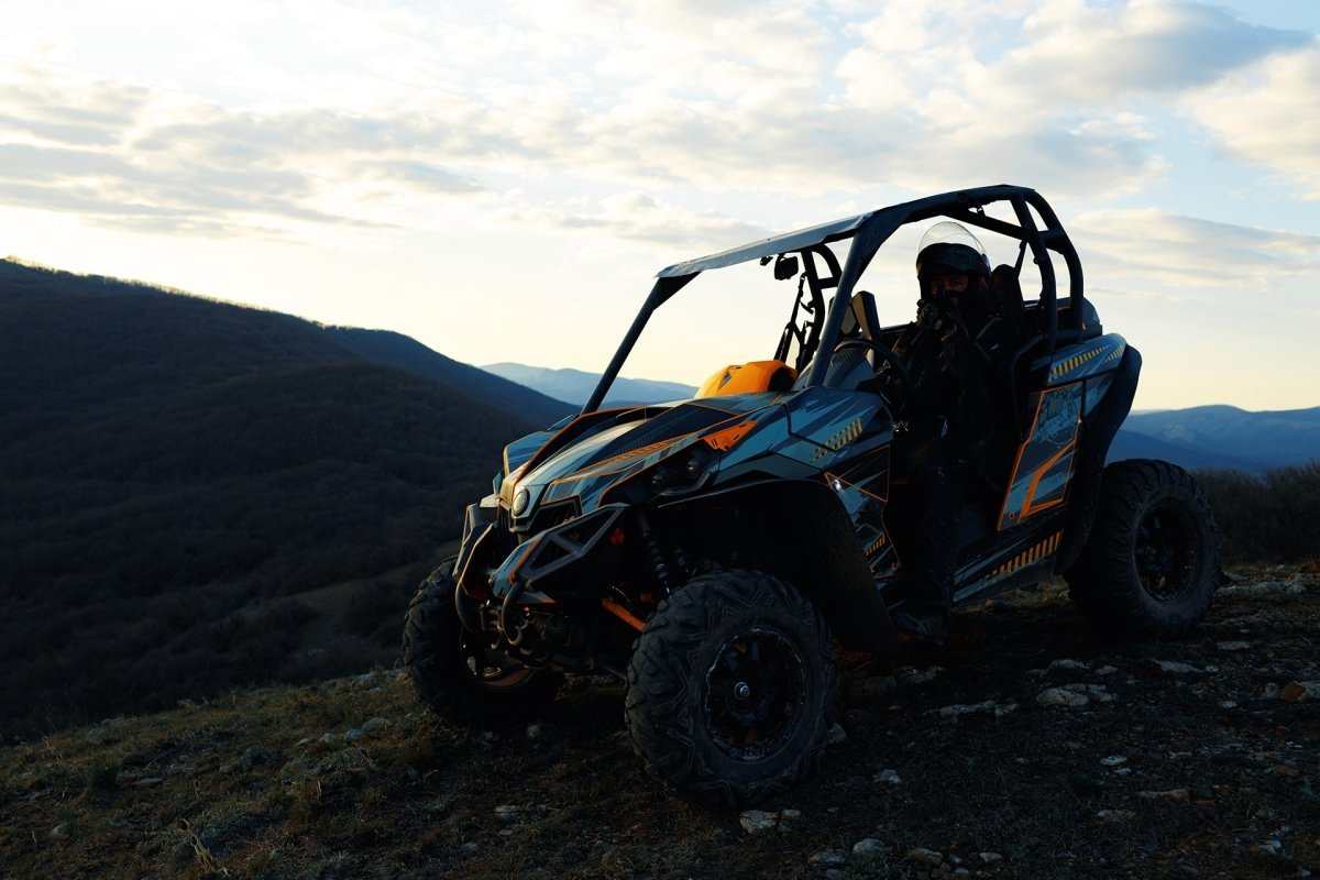 UTV off-road vehicle on a mountain trail at sunset in the US