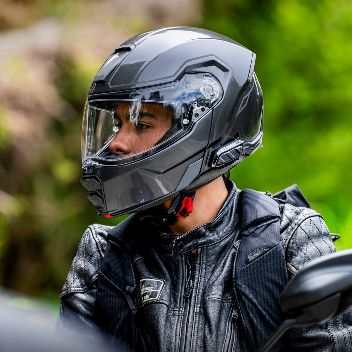 Sena SPIDER X Slim mounted on a rider's helmet; demonstration helmet sold separately