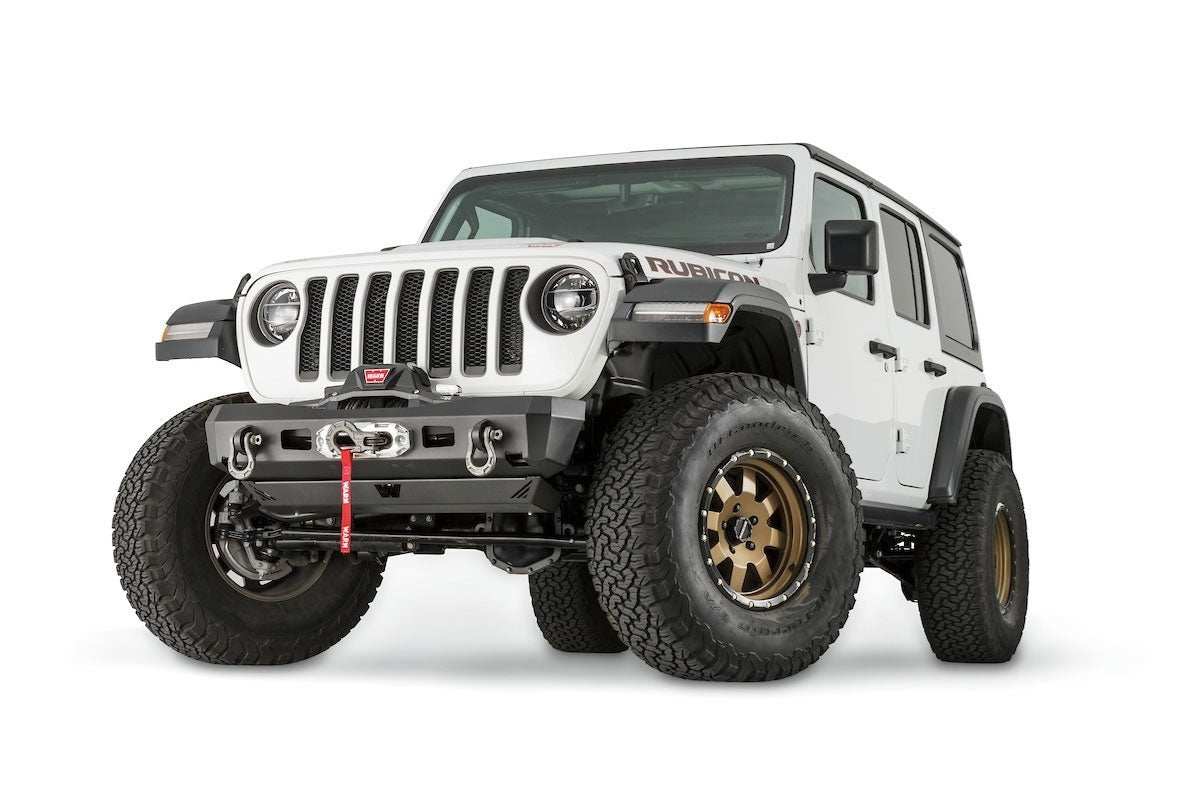 White Jeep Wrangler JL with Warn Elite Stubby Bumper installed, rugged front bumper designed for off-road durability and winch compatibility