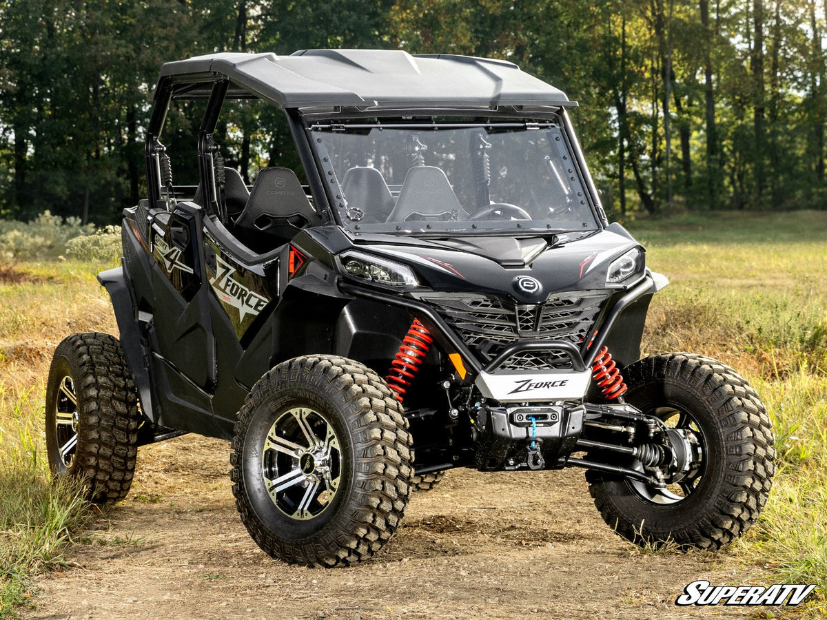 CFMOTO ZFORCE with SuperATV flip windshield on a wooded trail
