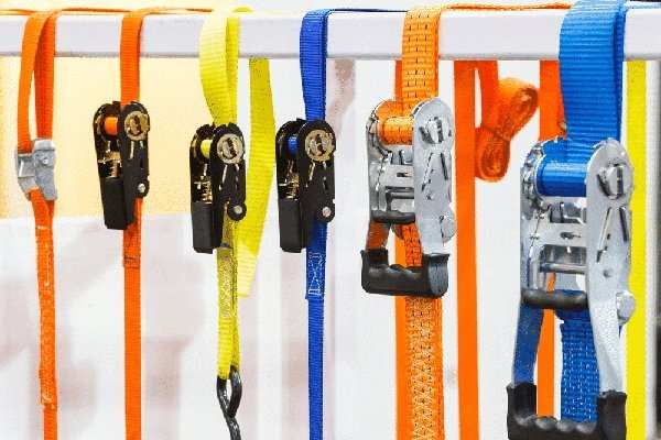 Colorful ratchet straps hanging for UTV tie down and trailer securing purposes