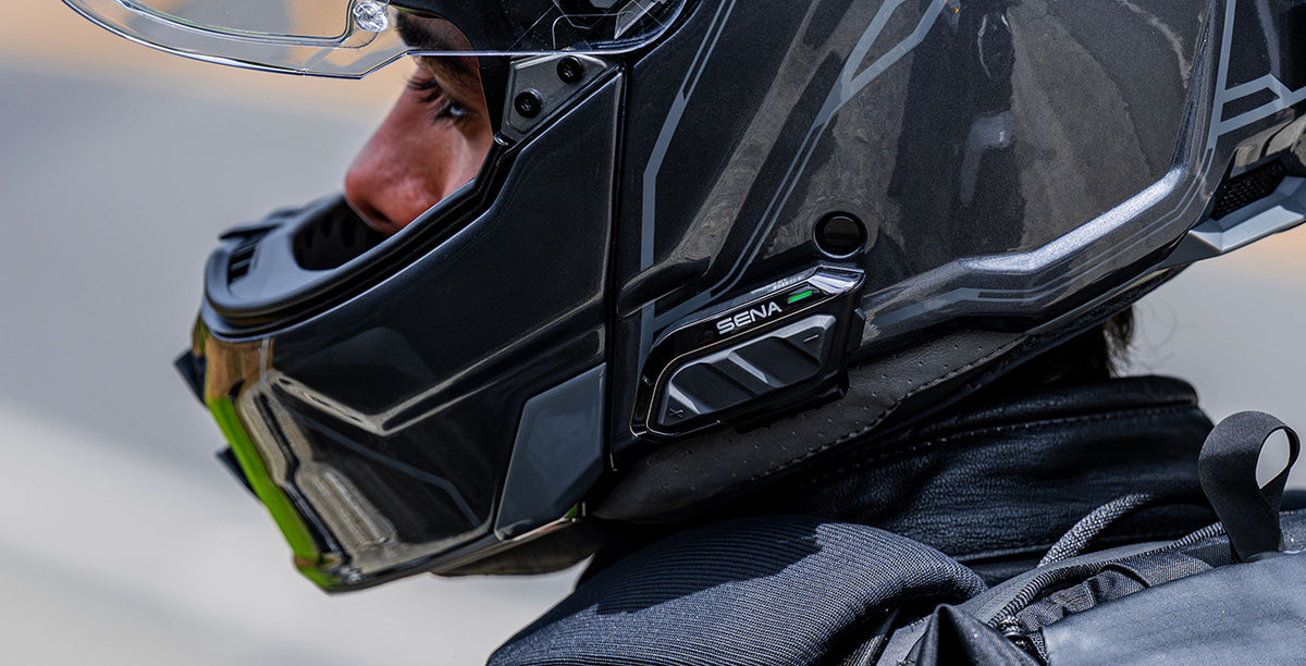 Close-up of Sena SPIDER X Slim controls and mounting position on a demonstration helmet